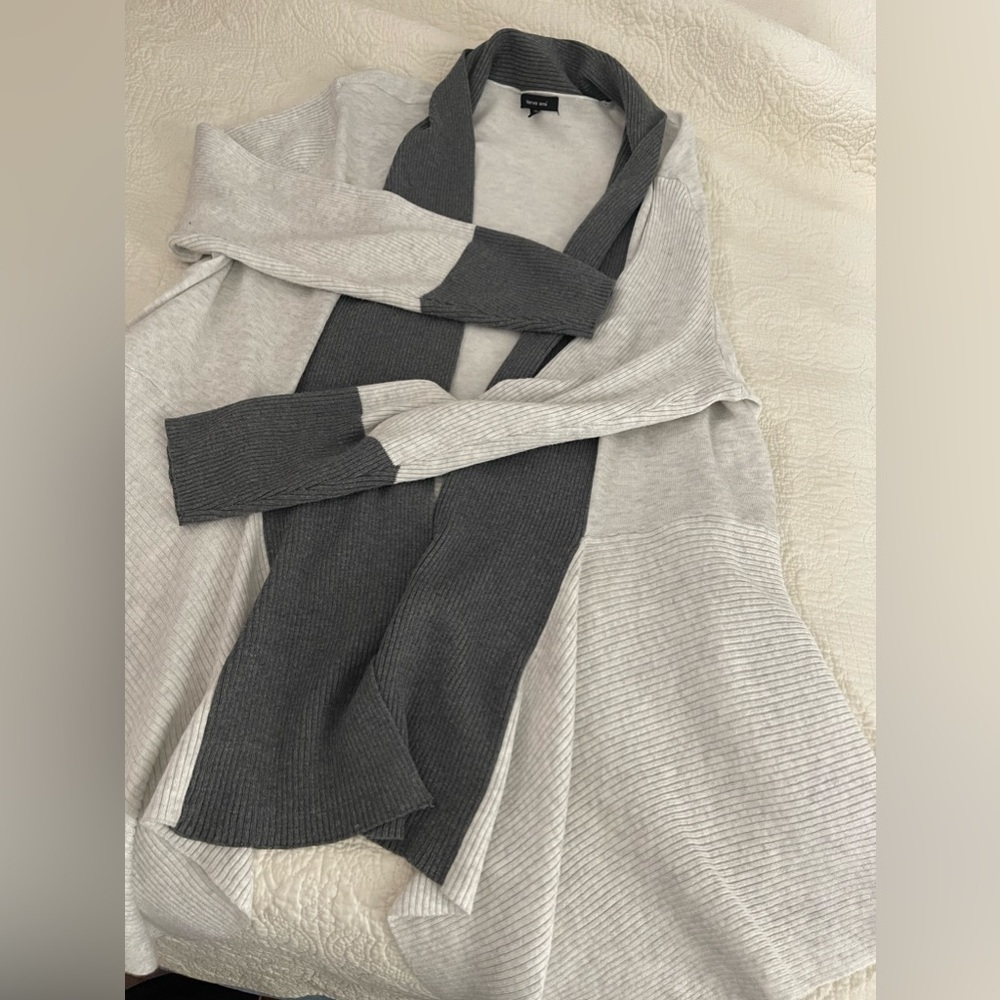Beautiful soft heather draped sweater with distinct and dramatic hemline.